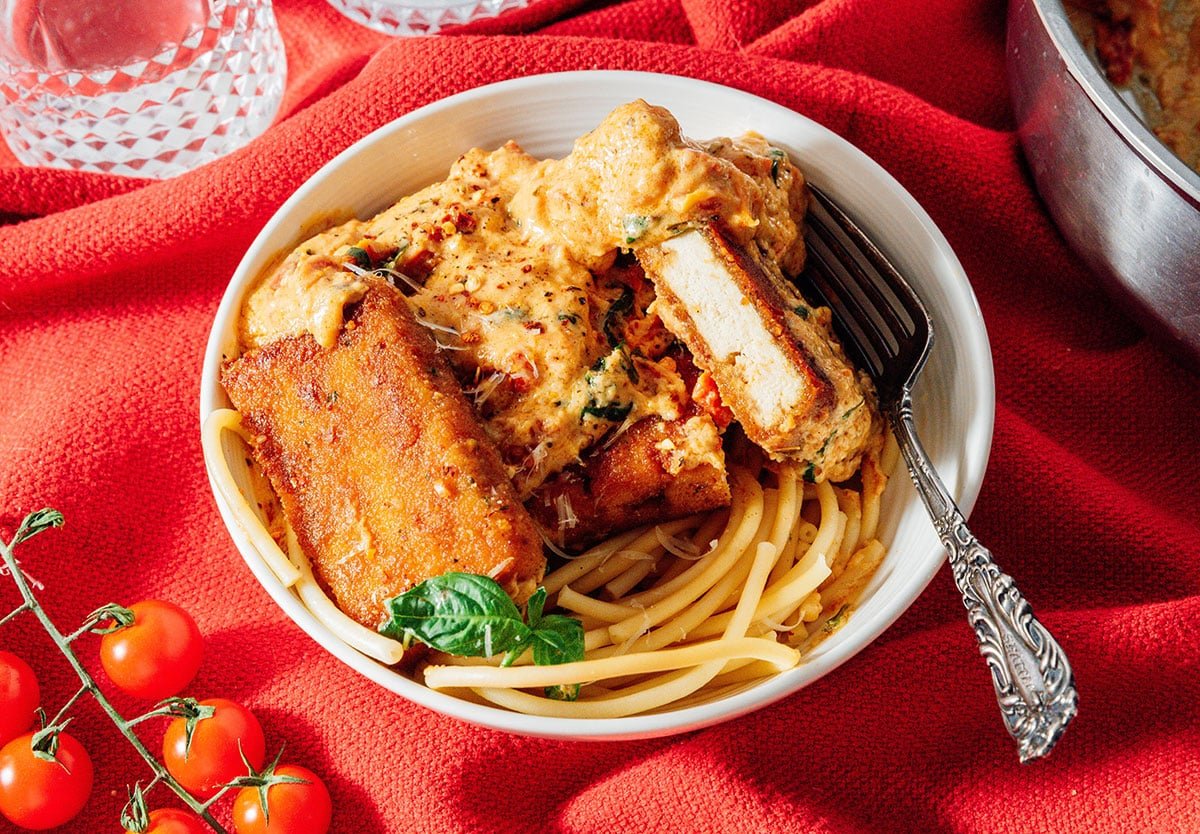 Vegan marry me chicken with pasta in a bowl.