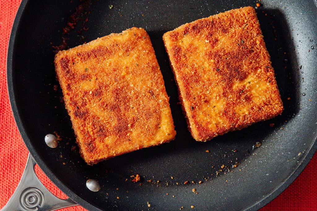 Cooking tofu in a pan.