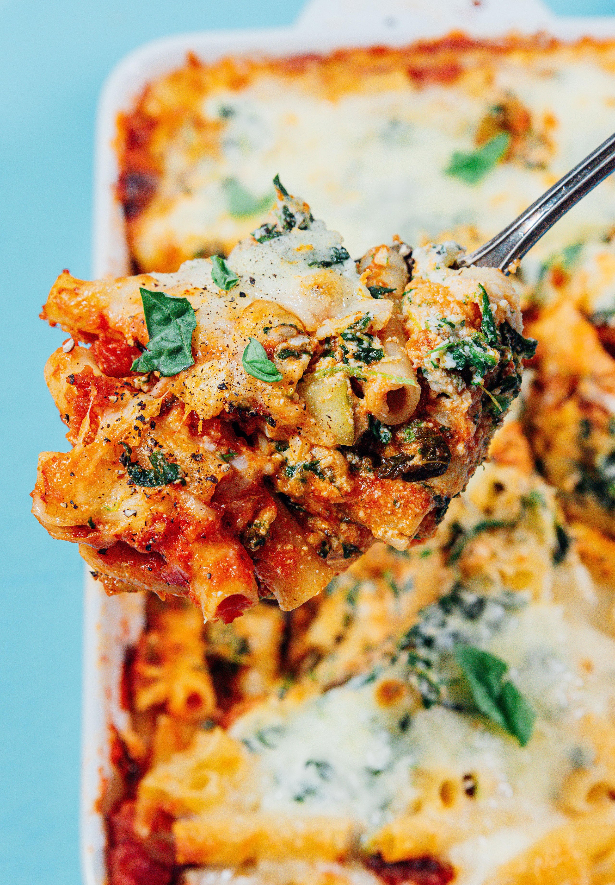 Baked ziti on a serving spoon.