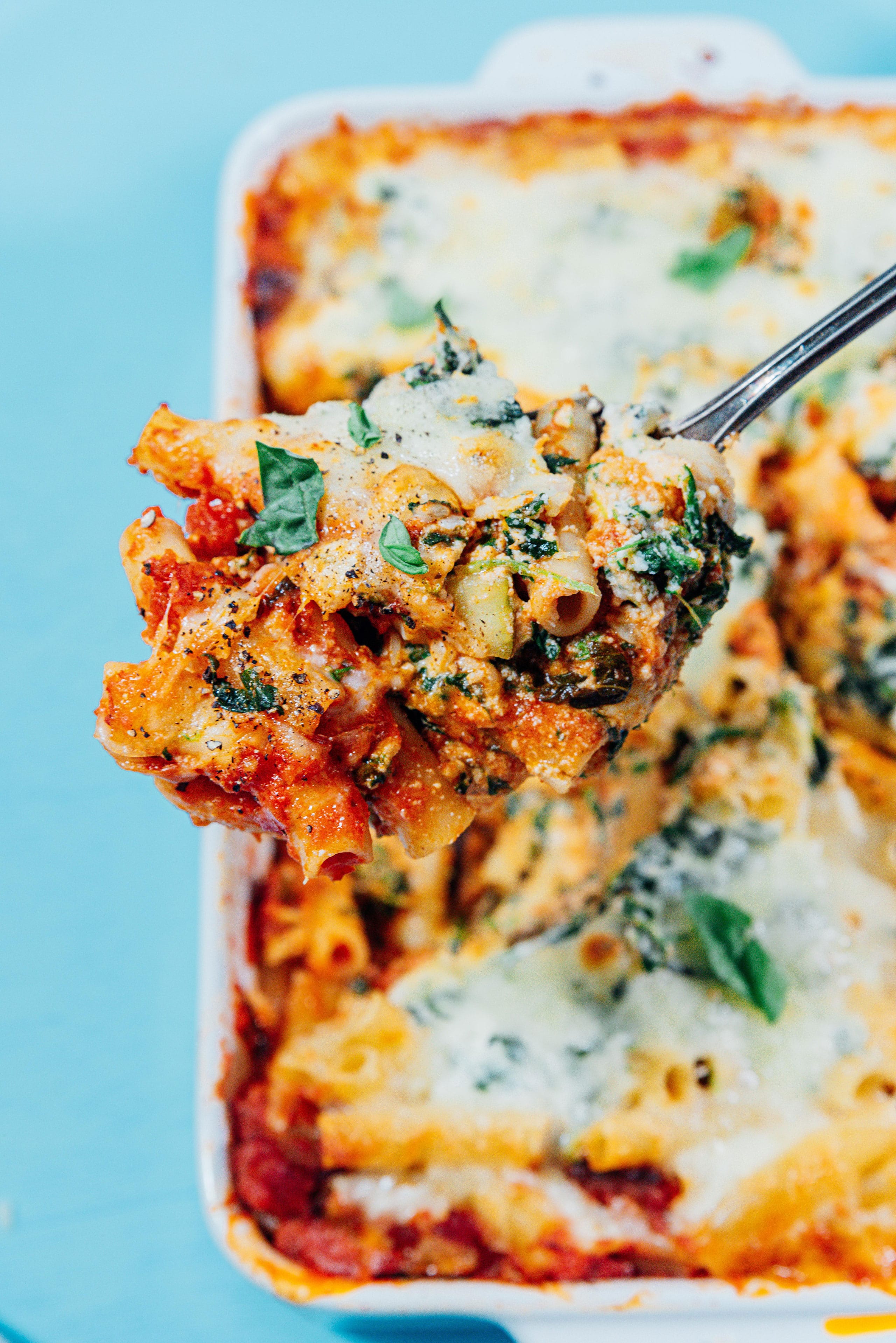 Baked ziti on a serving spoon.