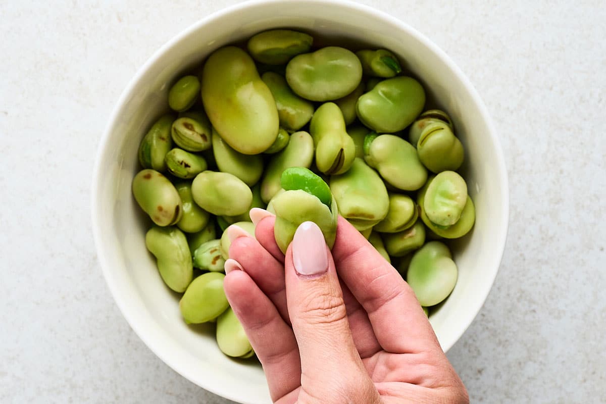 Peeling fava beans a second time.