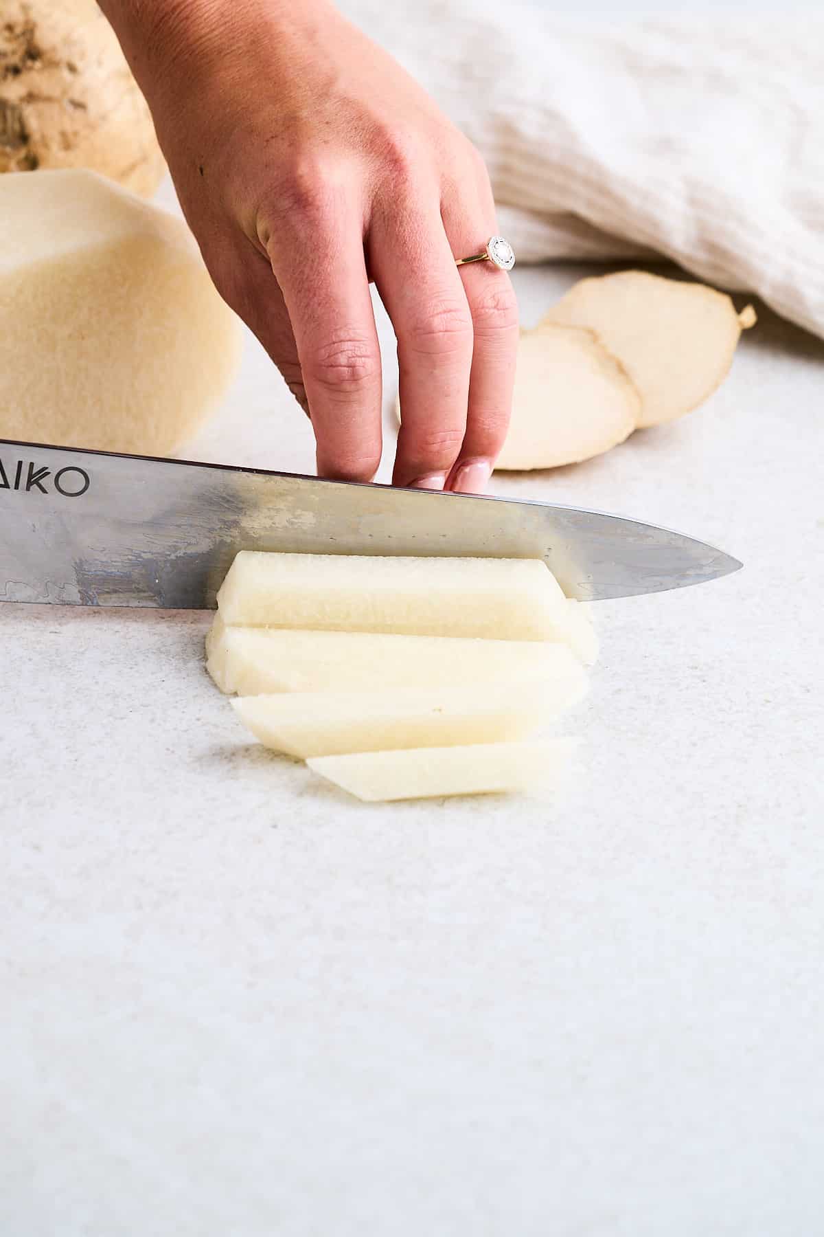 Cutting jicama into strips.