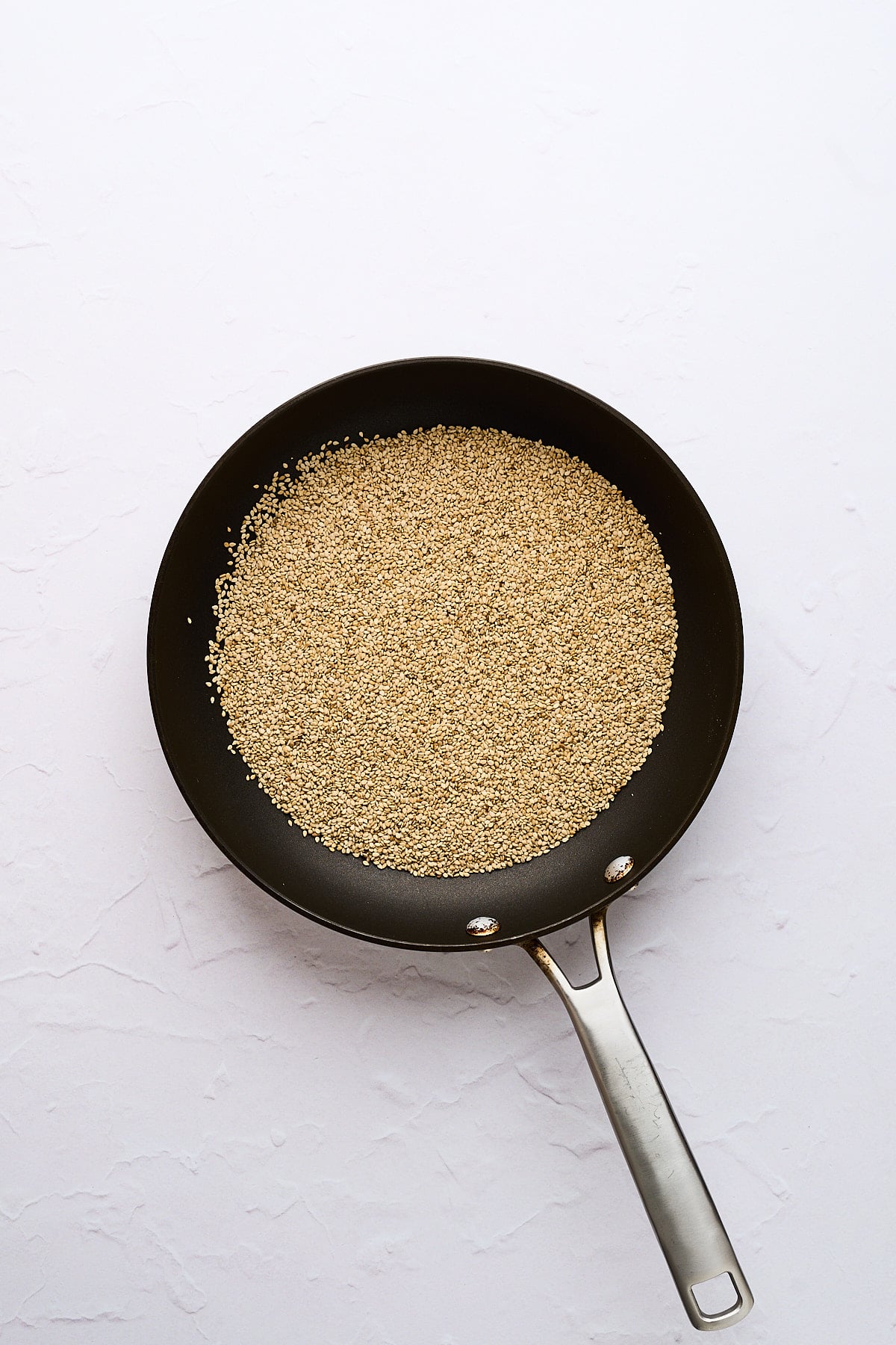 Toasted sesame seeds in a pan.