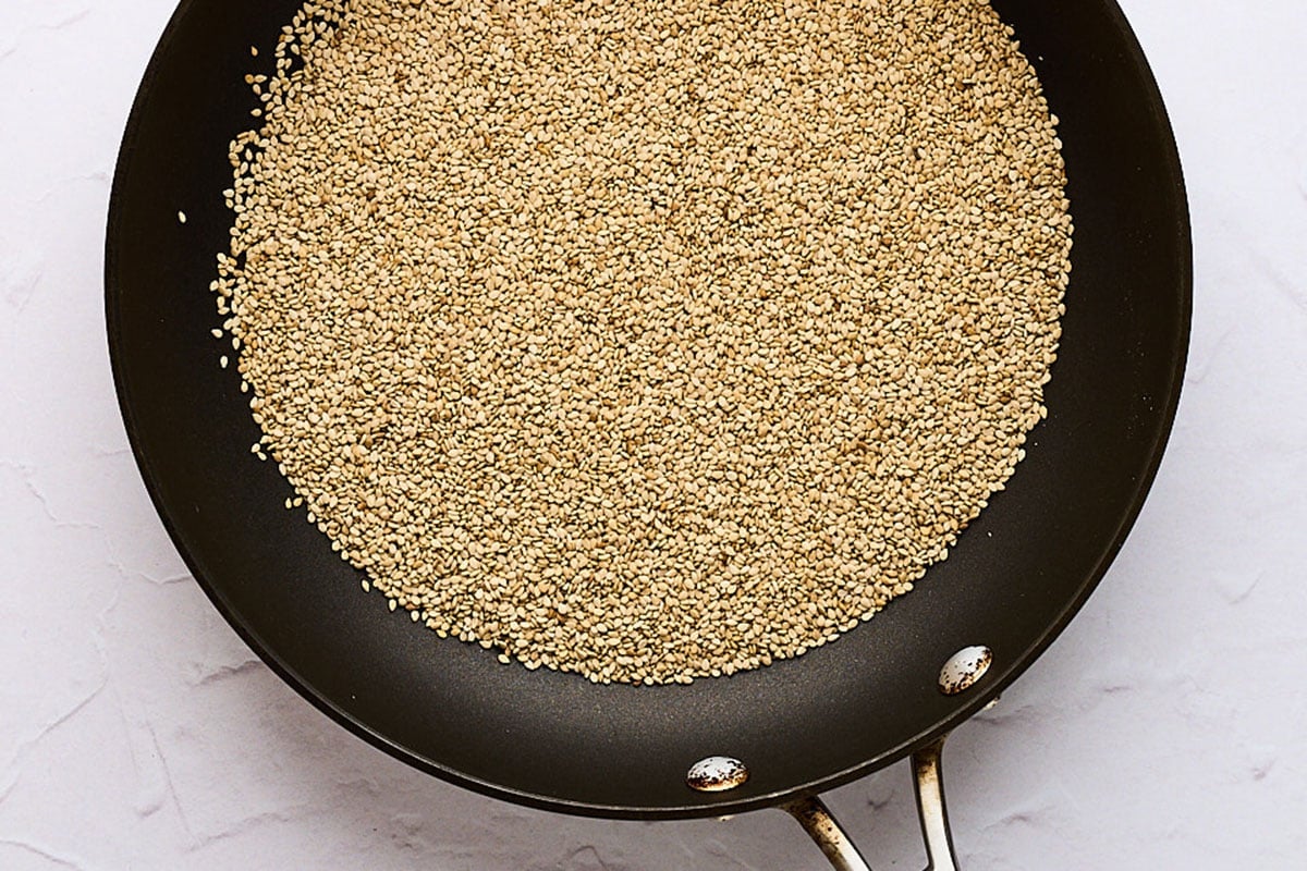 Toast sesame seeds in a pan.