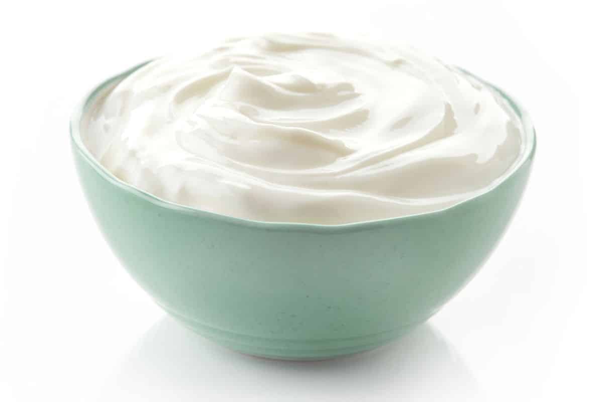 A bowl of australian yogurt on a white background.