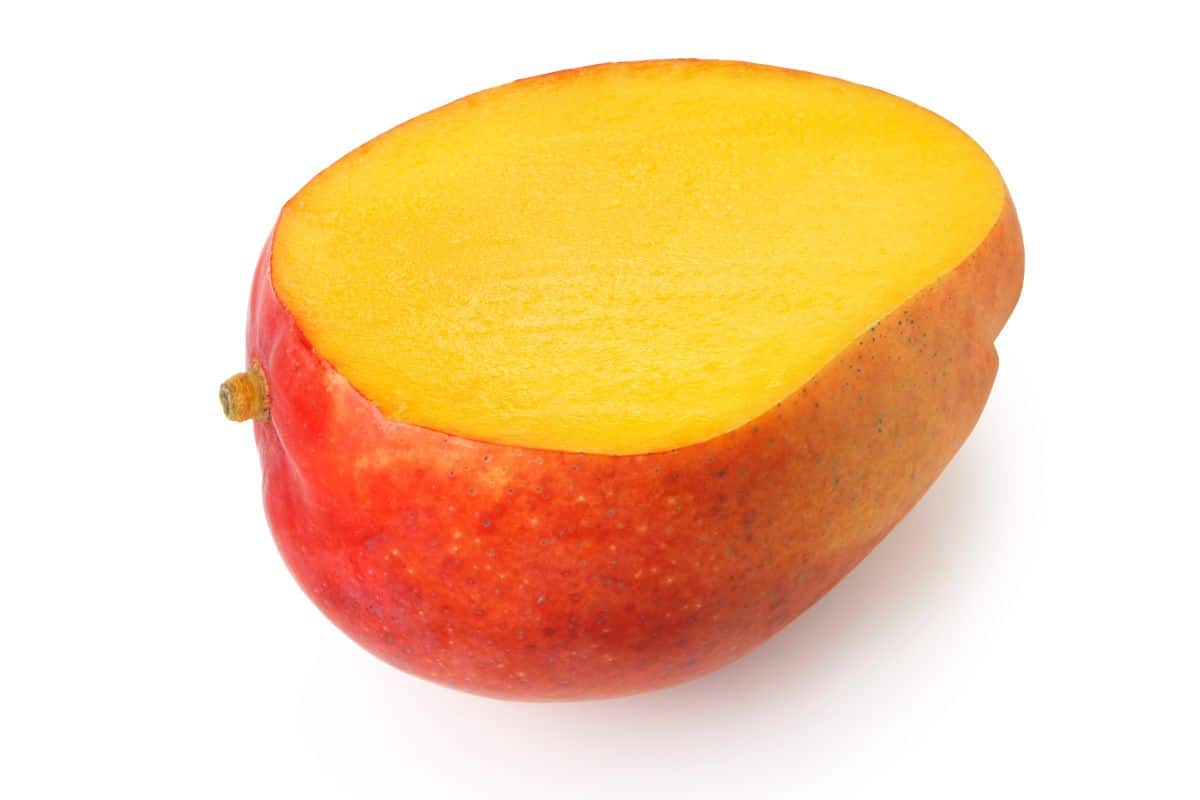 Haden mango sliced open on a white background.
