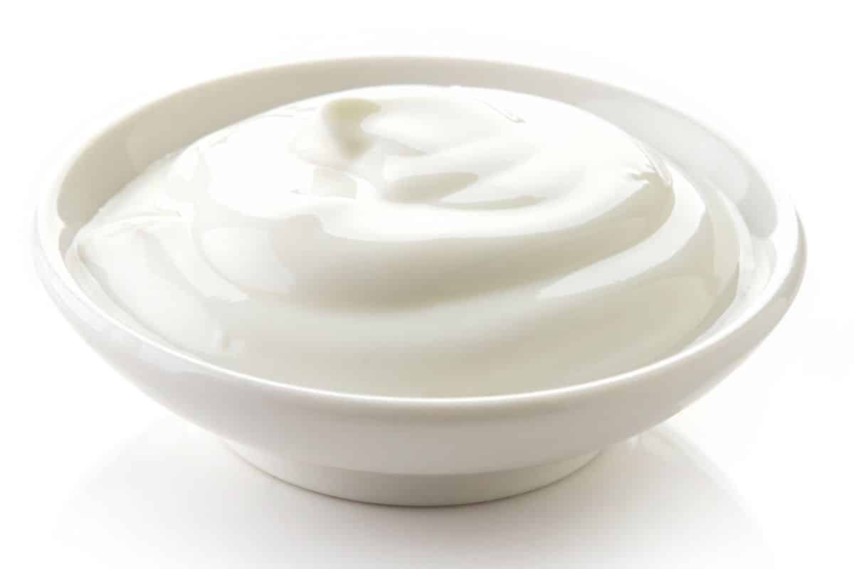 Low fat yogurt in a bowl on a white background.
