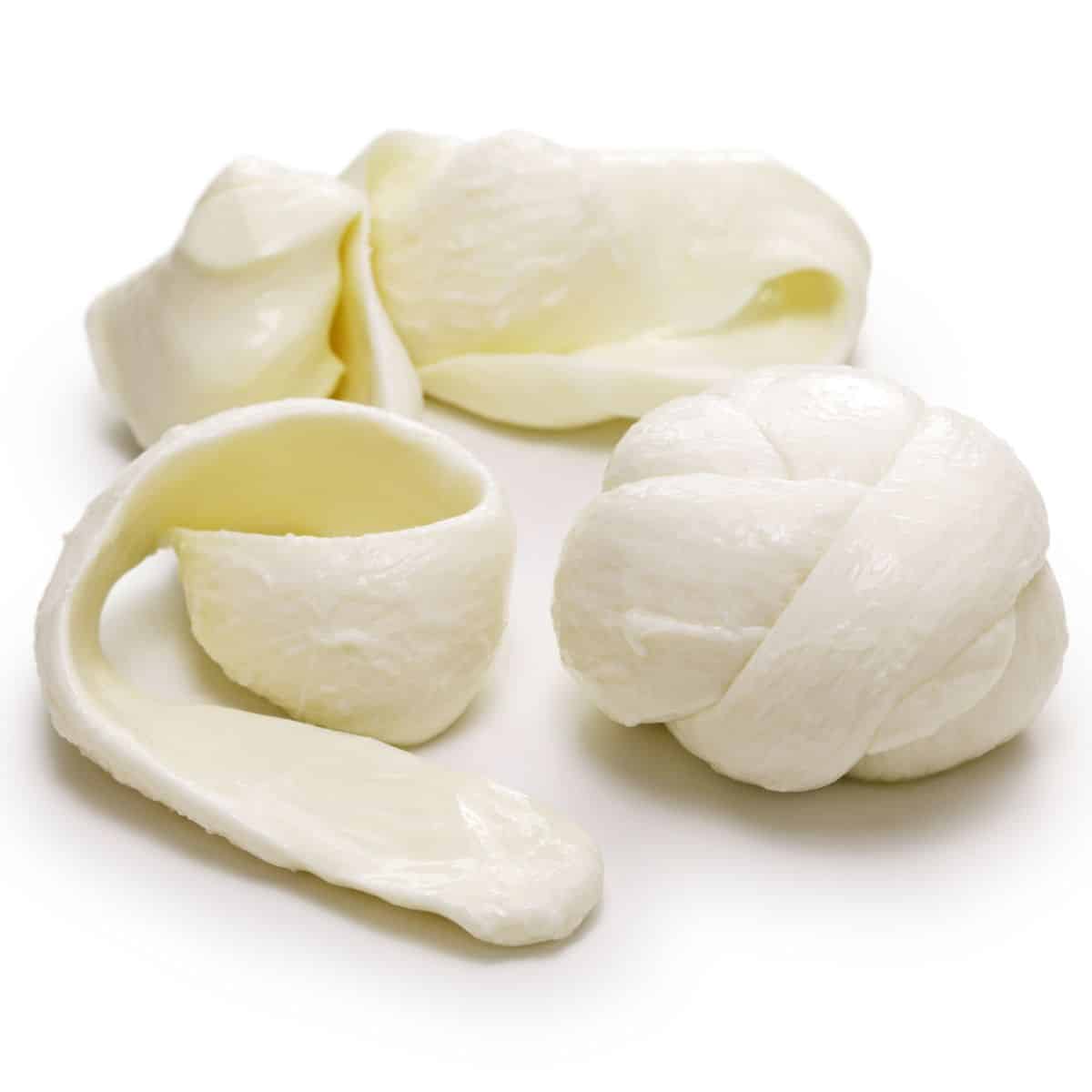 Oaxaca cheese unrolled on a white background.