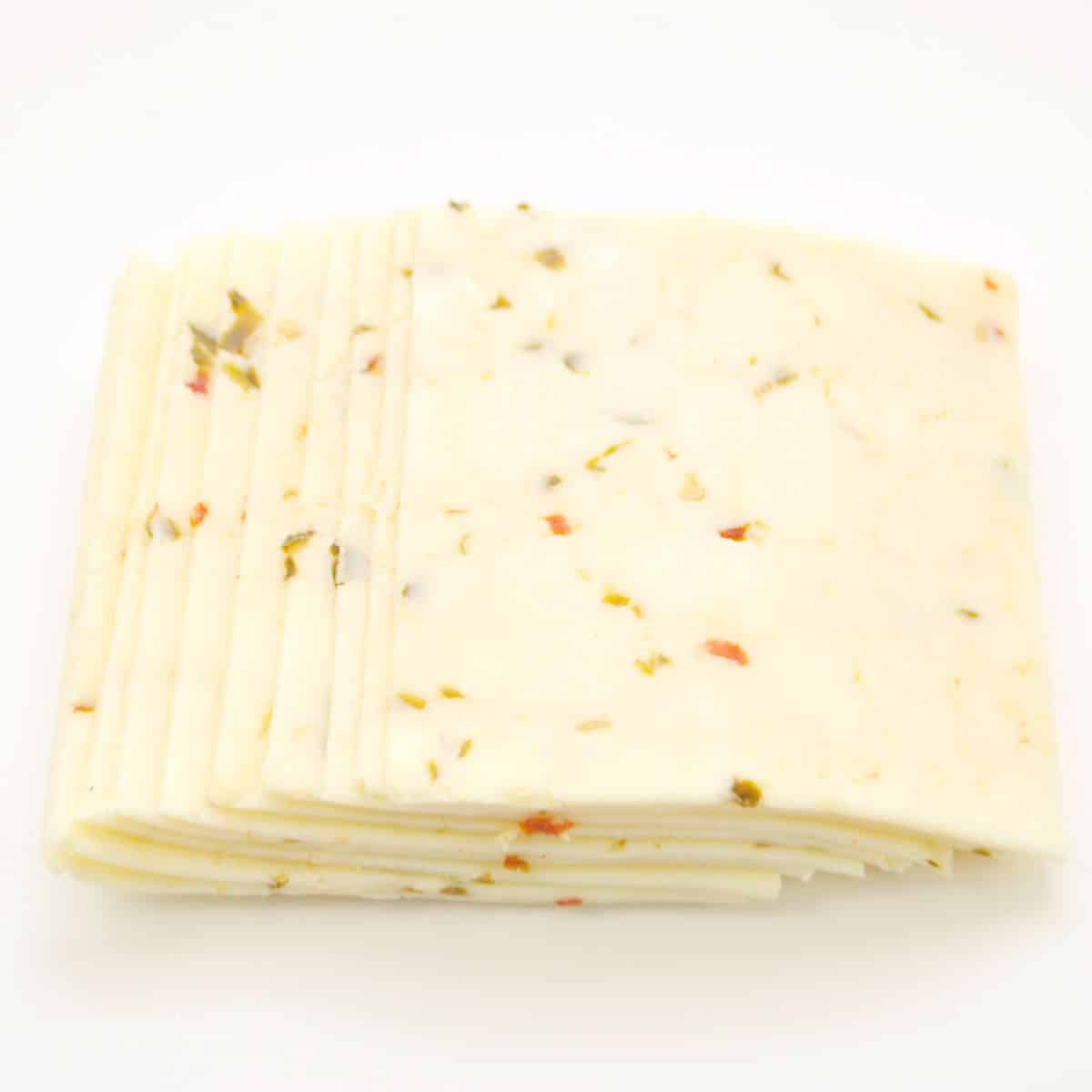 Slices of pepper jack cheese on a white background.