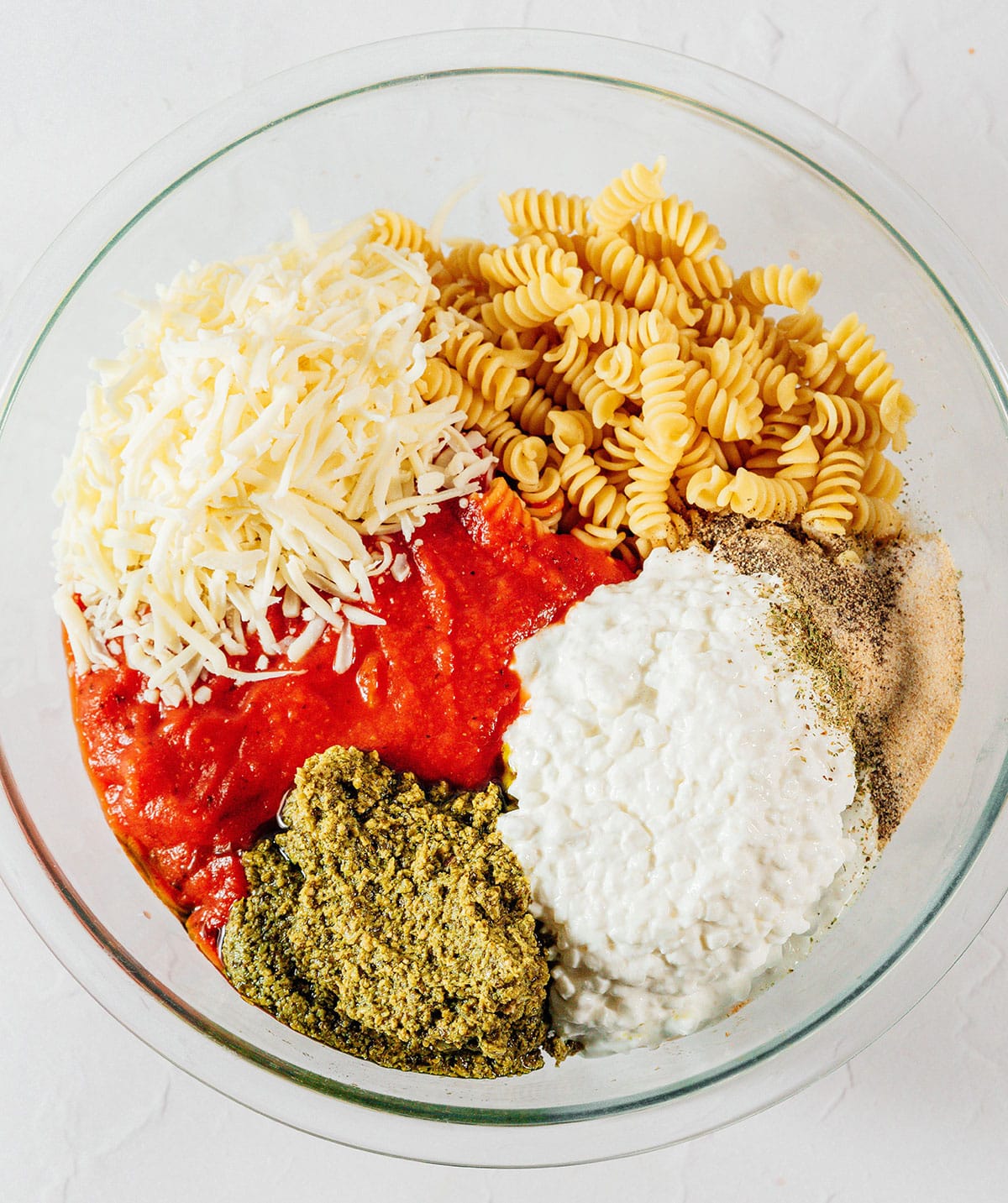 Ingredients for rotini bake in a bowl.