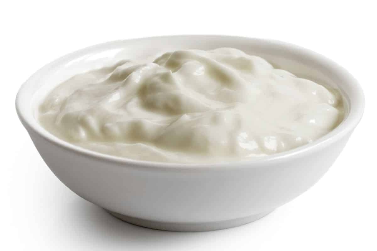 A bowl of skyr yogurt on a white background.