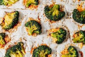Smashed broccoli on a baking sheet..