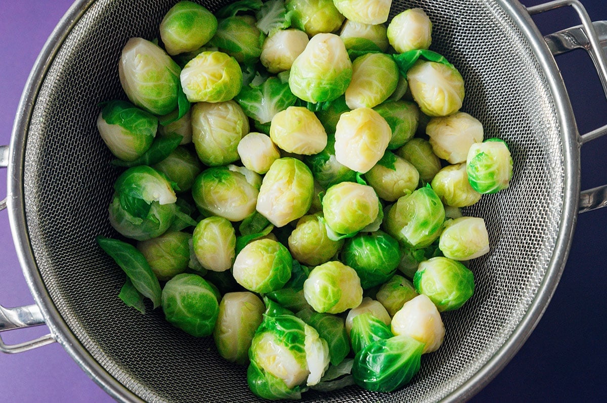 Draining brussels sprouts.