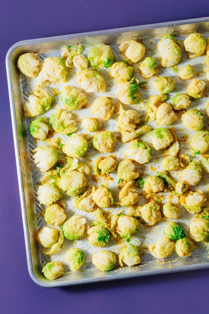 Smashed Brussels sprouts on a baking sheet.