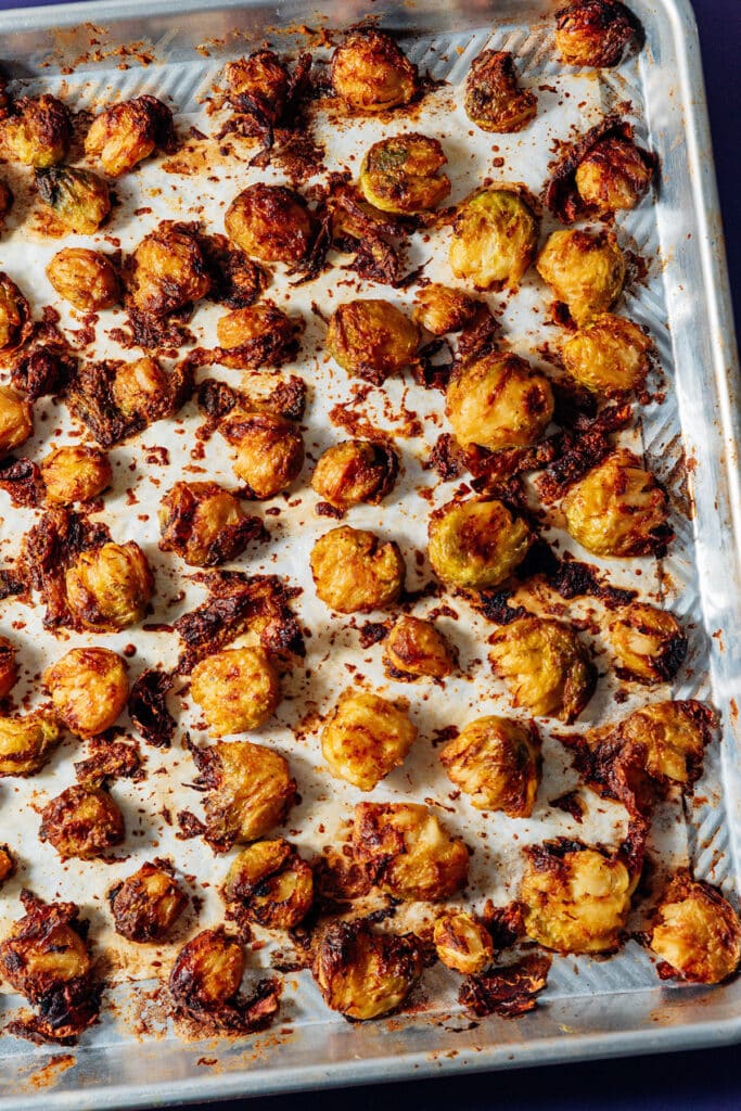 Crispy baked smashed Brussels sprouts on a baking sheet.