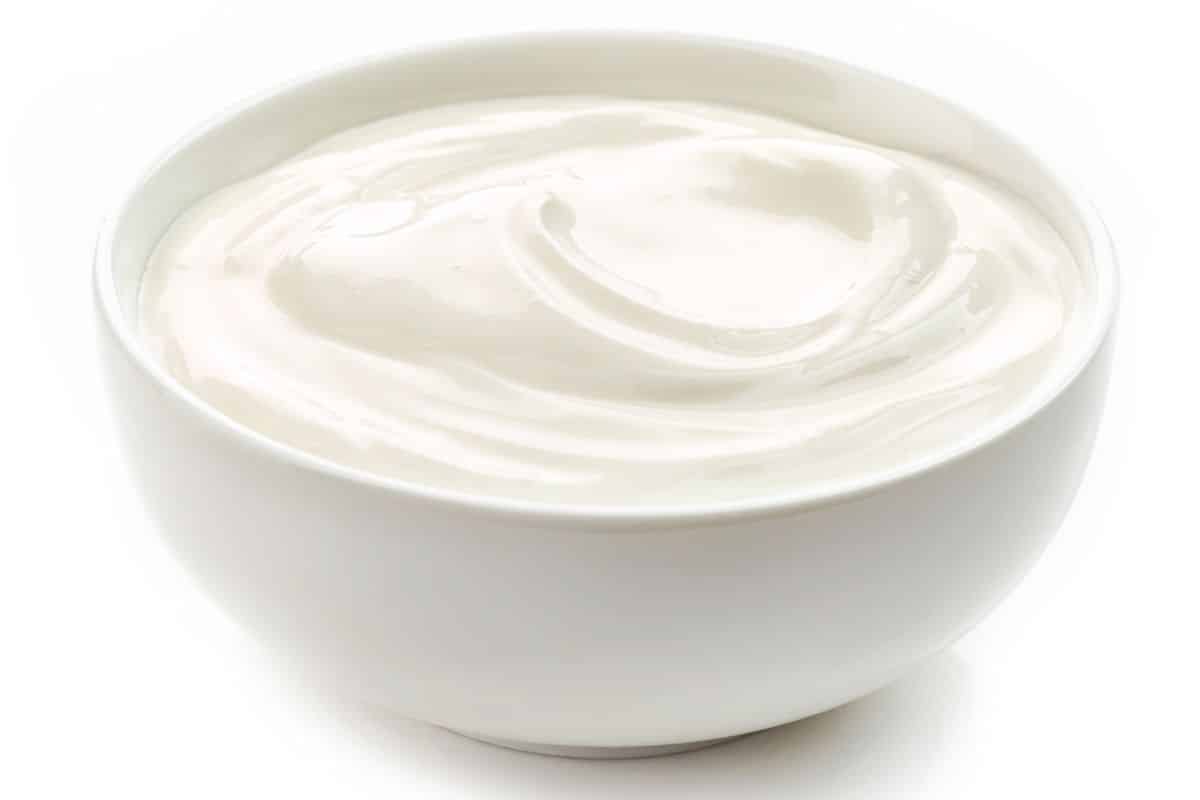 A bowl of sugar free yogurt on a white background.