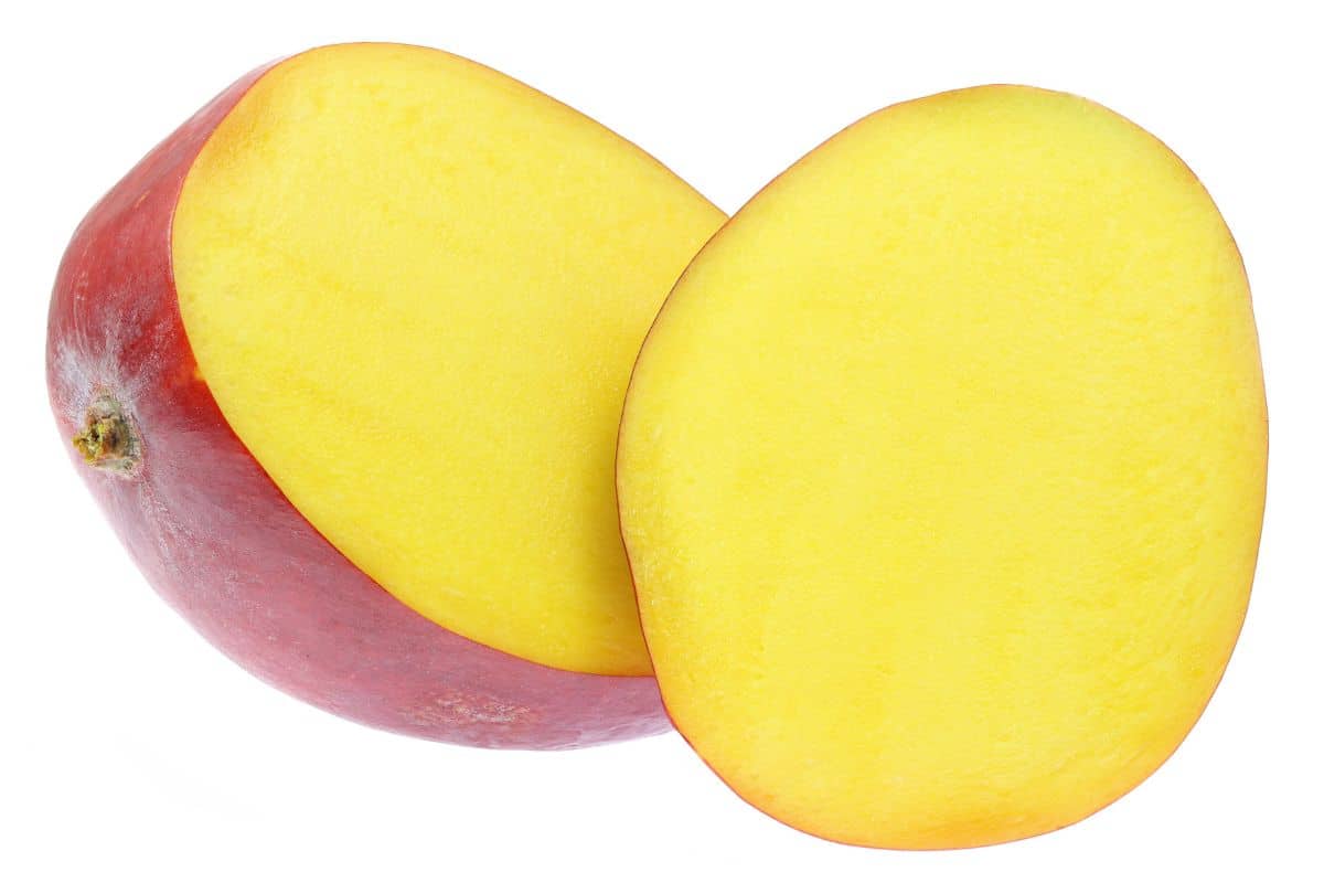 tommy atikins mango sliced open on a white background.