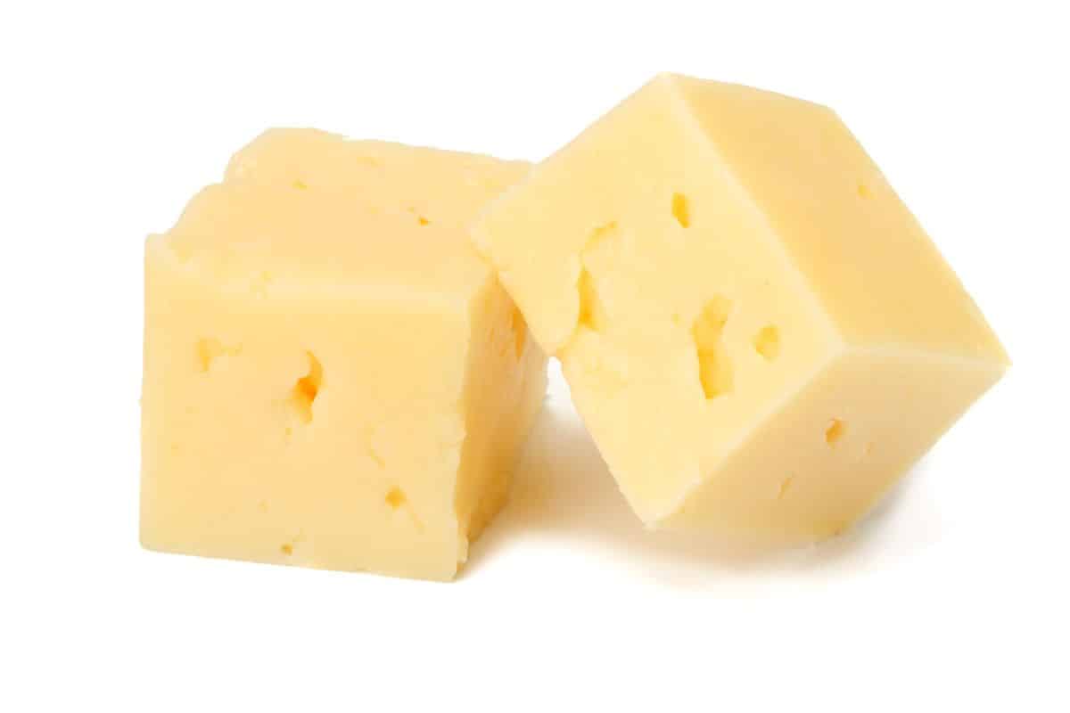 White cheddar cheese on a white background.