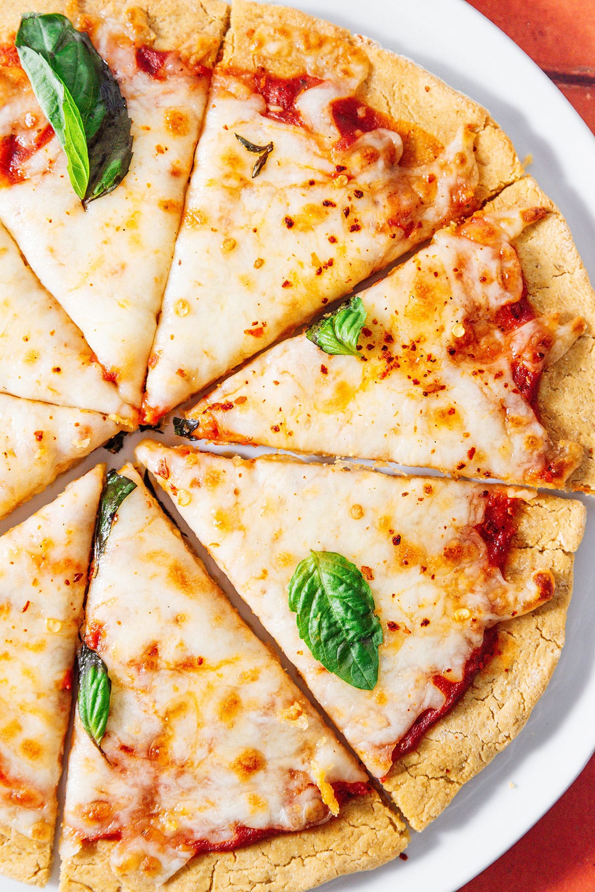 Chickpea pizza crust with cheese and basil.