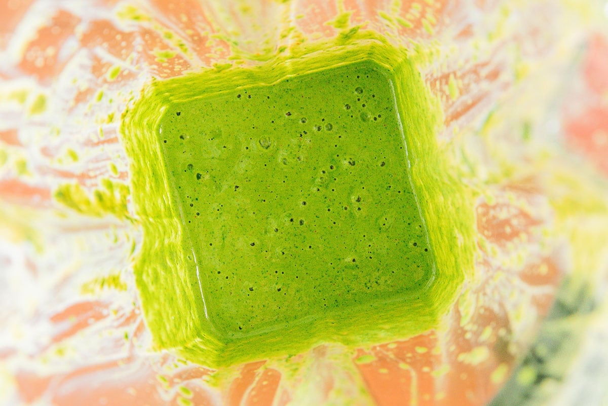 Green sauce in a blender.