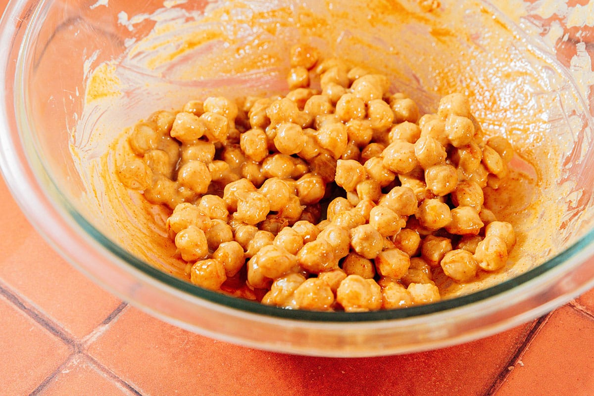 Mixing chickpeas with tahini.