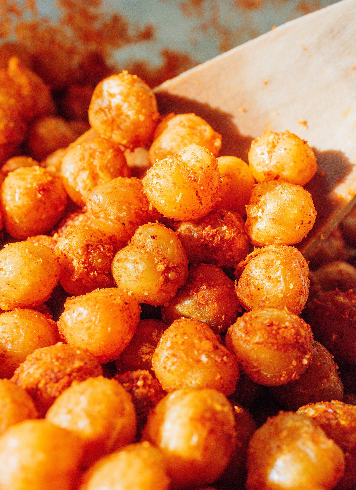 Fried chickpeas close up with a wooden spoon.