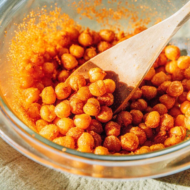 Fried chickpeas close up with a wooden spoon.