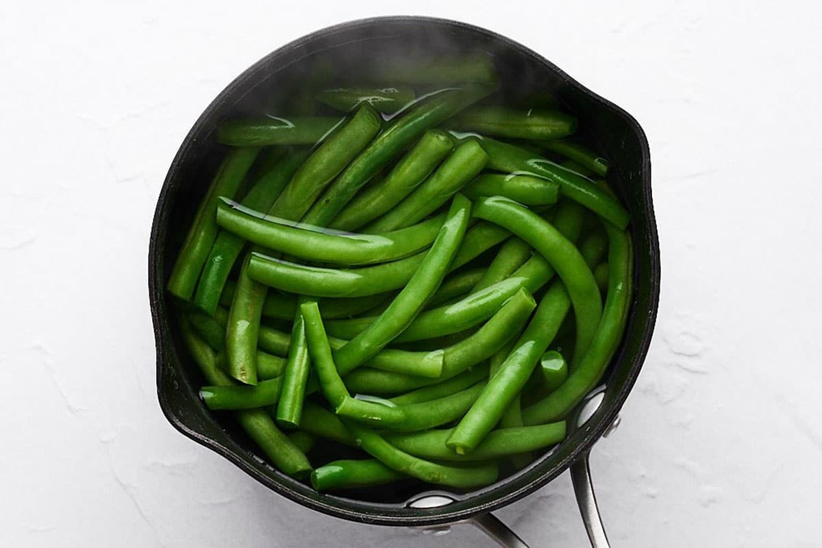 Green beans in a pot of water.