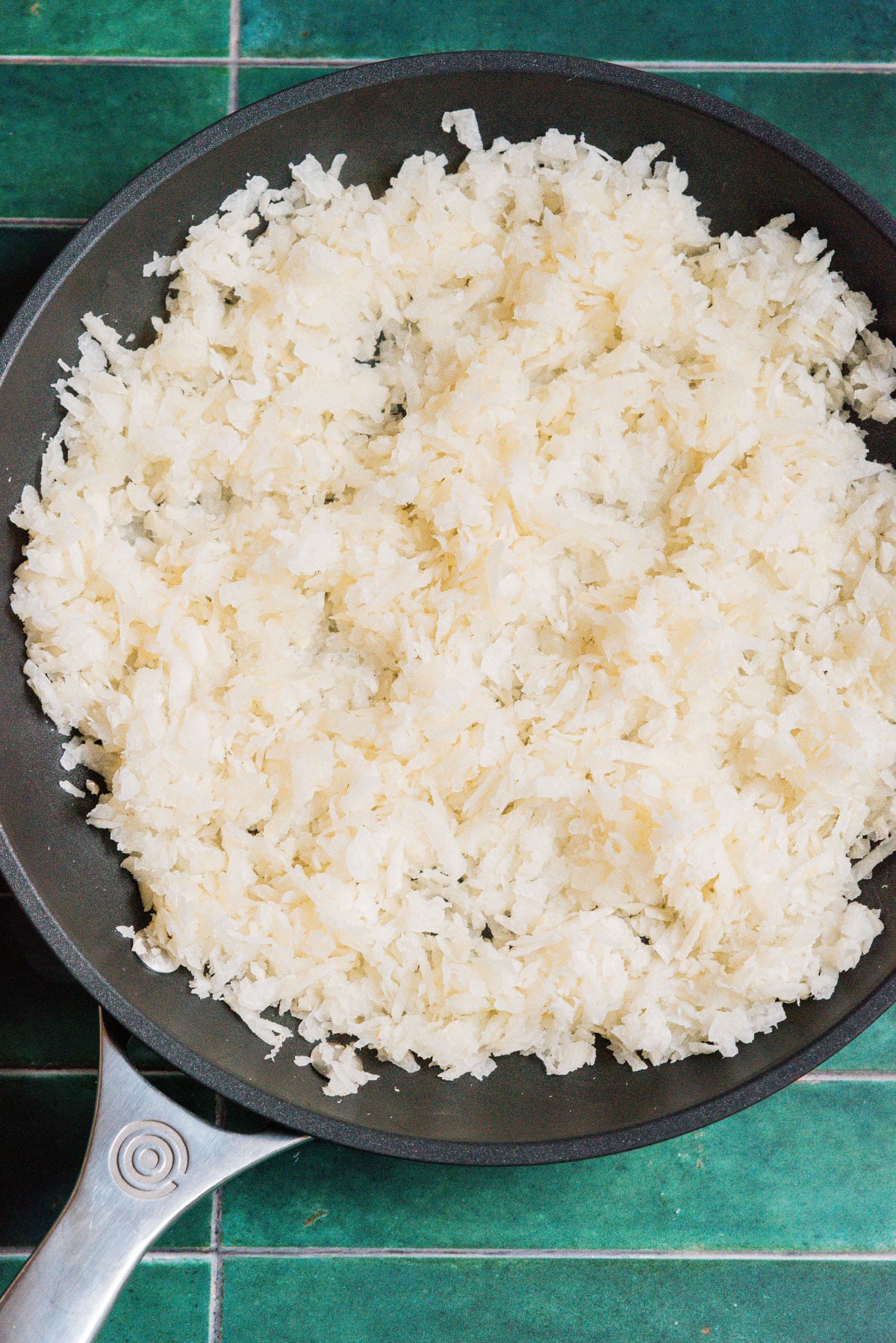 Jicama rice in a saute pan.