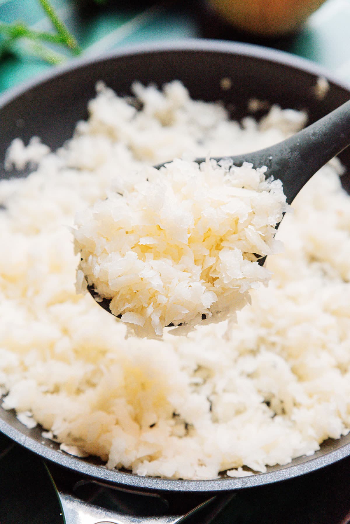 Jicama rice on a spoon.