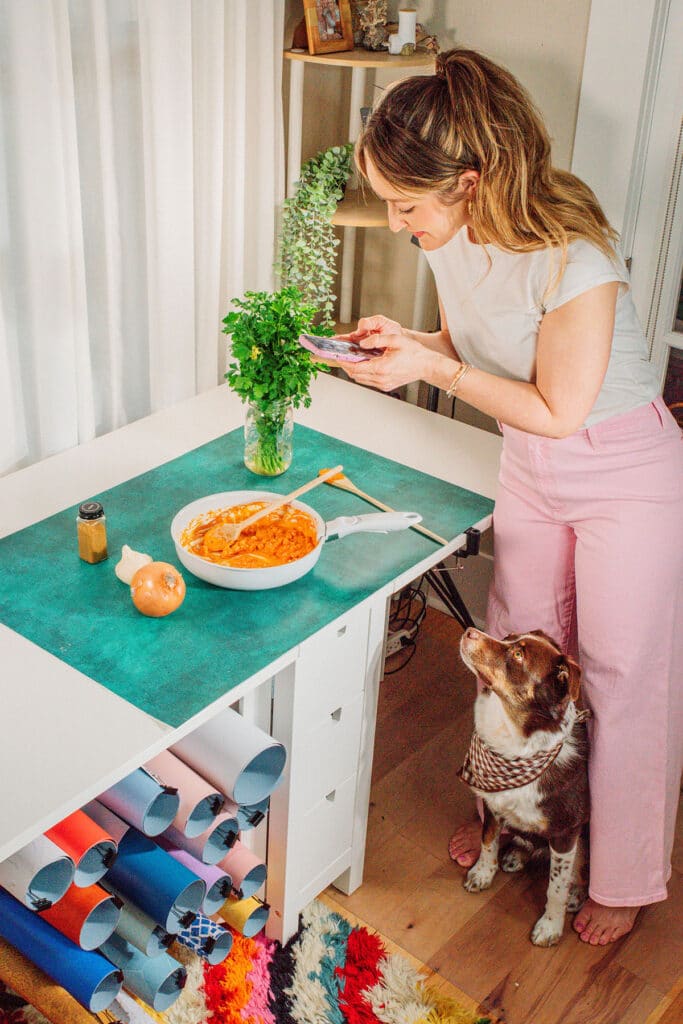 Sarah Bond, the vegetarian food blogger behind Live Eat Learn, working in her studio with dog, Rhubarb.