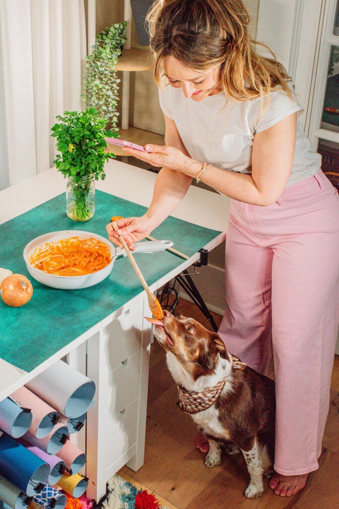 Sarah Bond, the vegetarian food blogger behind Live Eat Learn, working in her studio with dog, Rhubarb.