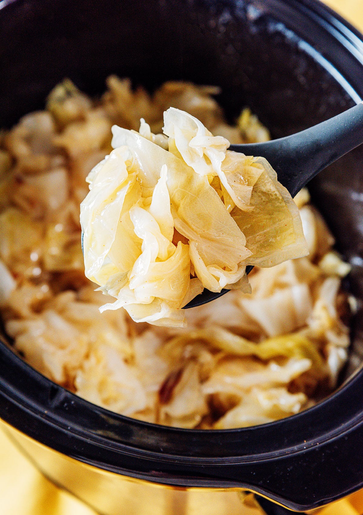 Slow cooker cabbage on a spoon.