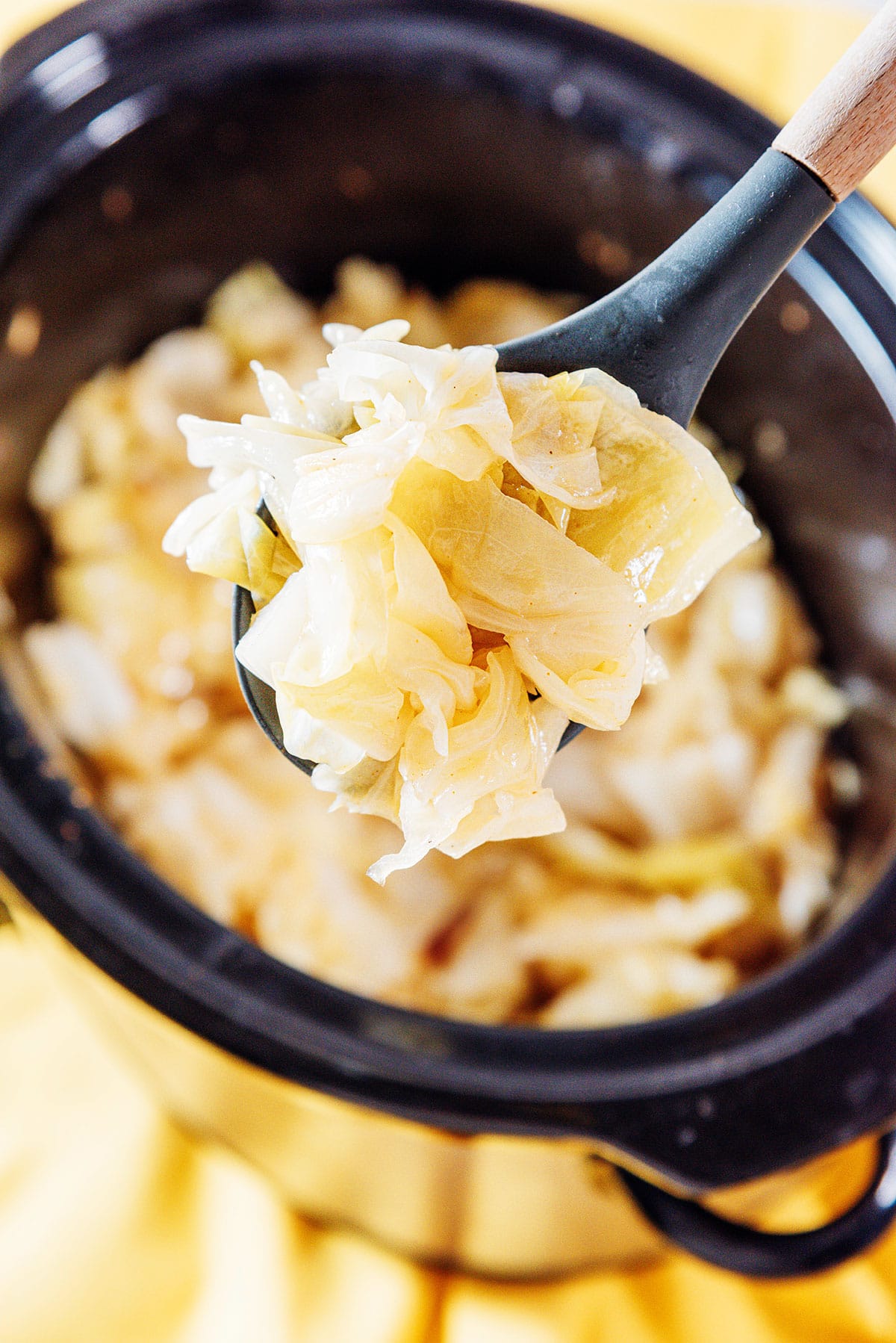 Slow cooker cabbage on a spoon.