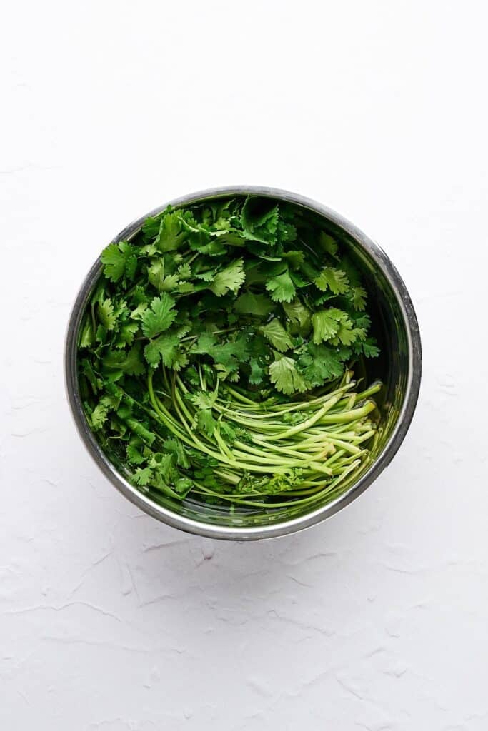 Cilantro in a bowl of water.