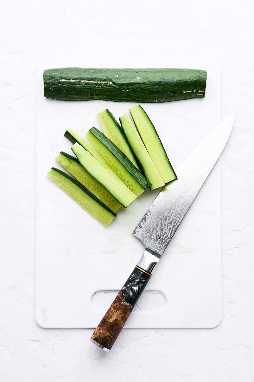 Cutting a cucumber into sticks.