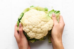 Removing leaves from a cauliflower head.