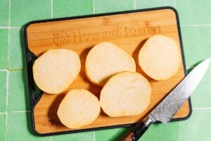 Cutting rutabaga into slabs.