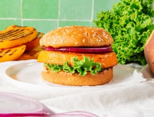 Rutabaga burgers with a green tile background.