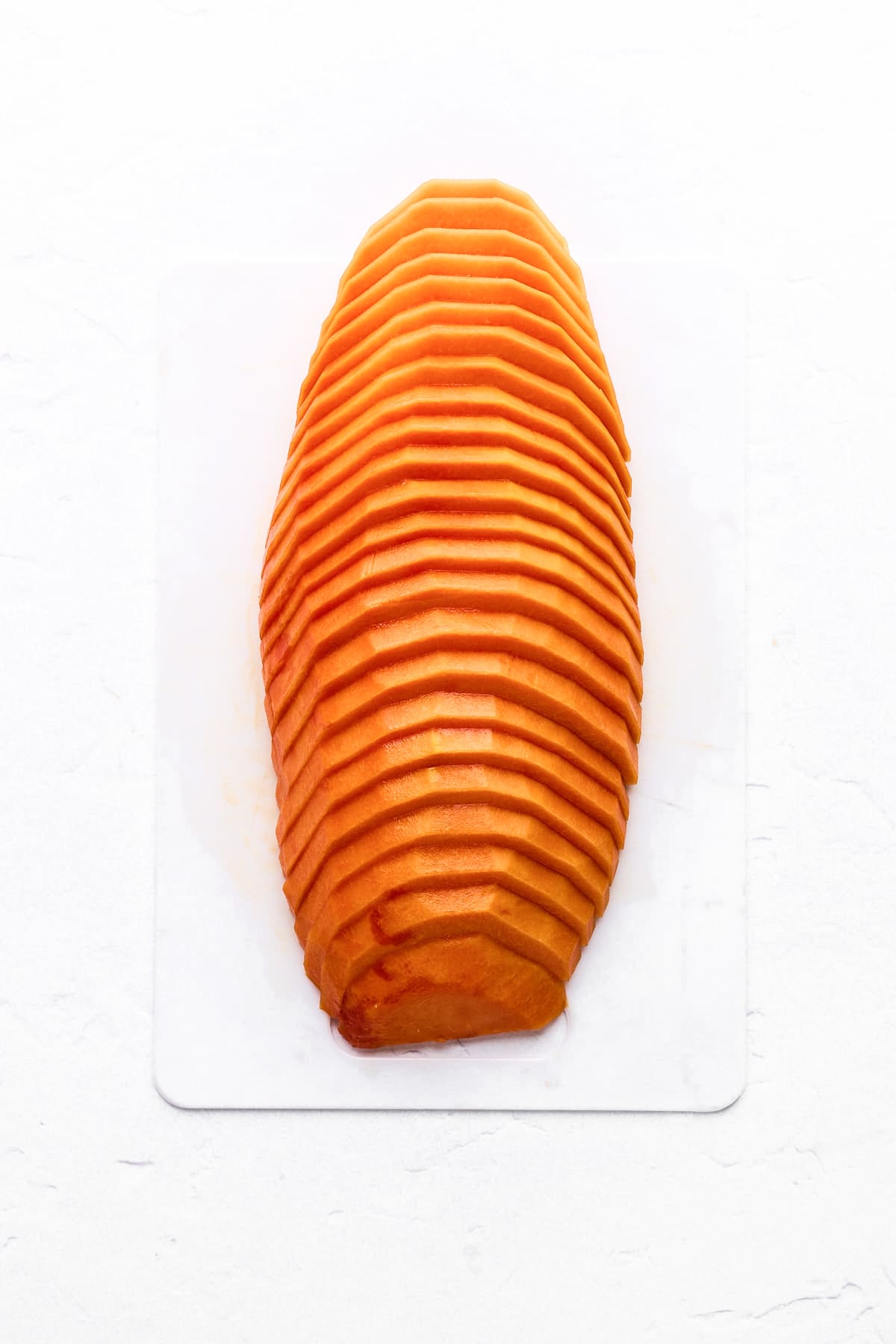 Papaya half cut into thin slices.