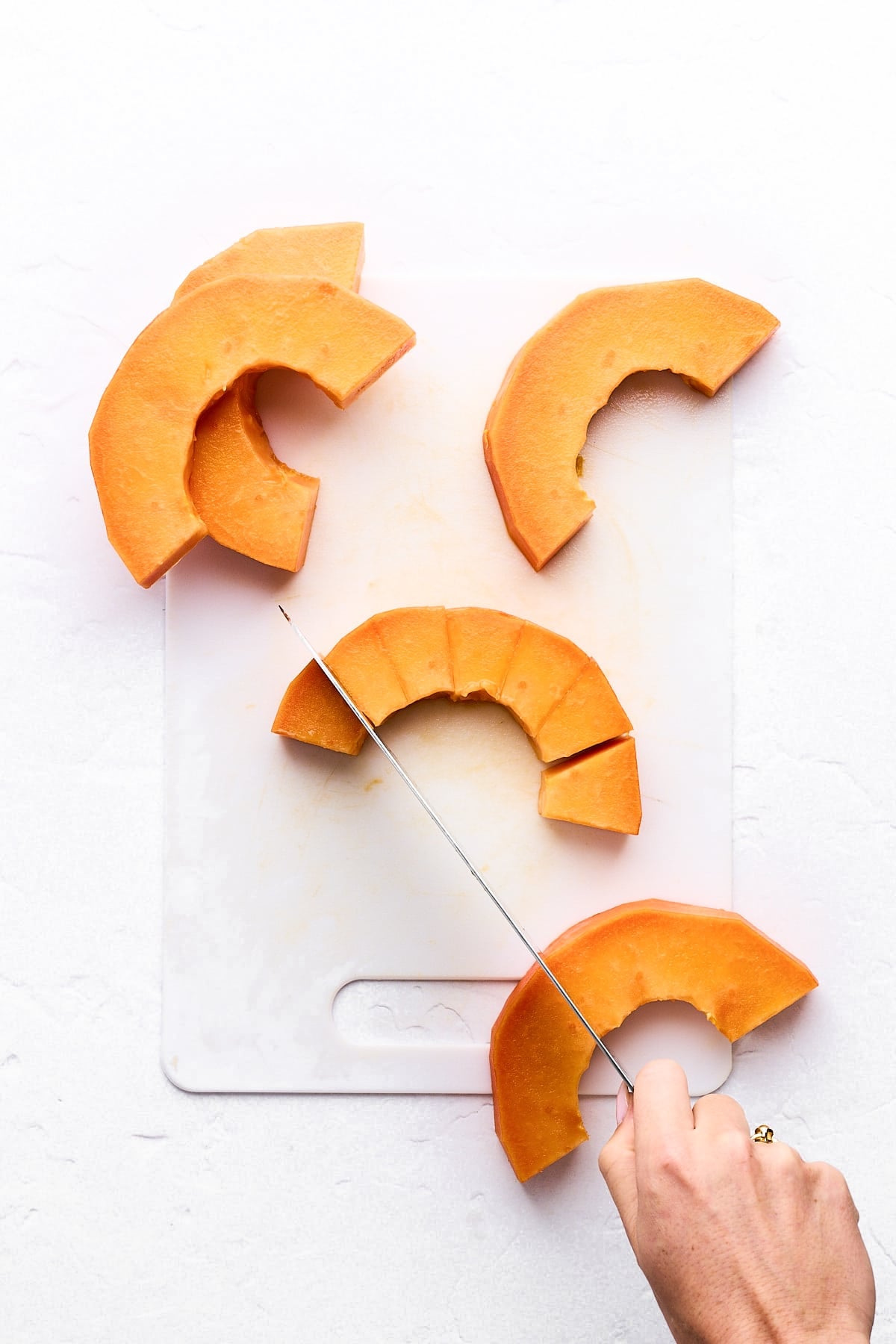 Cutting a papaya slice into cubes.