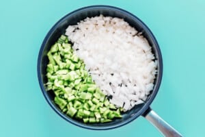 Onion and green bell pepper in a pan.