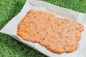 Shaping dog treat dough on a baking sheet.