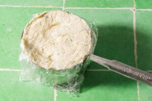 Shaping boursin cheese in a cup.