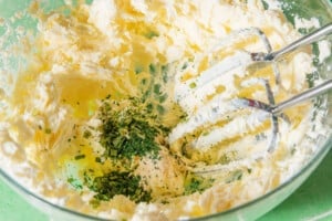Whipping ingredients to make Boursin cheese.
