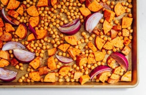 Roasted chickpeas and sweet potato on a tray.
