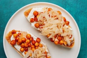 Chickpeas toast with whipped goat cheese and sauerkraut.