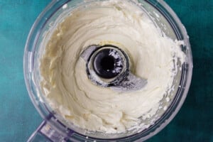 Whipping goat cheese in a food processor.