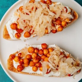 Chickpeas toast with whipped goat cheese and sauerkraut.