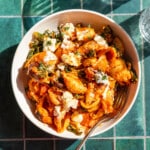 Pumpkin pasta bake in a white bowl.
